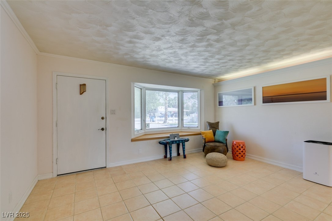 4087 Pleasant Road Las Vegas, NV 89108 - Photo 13 of 74 Living area with light tile patterned floors and crown molding