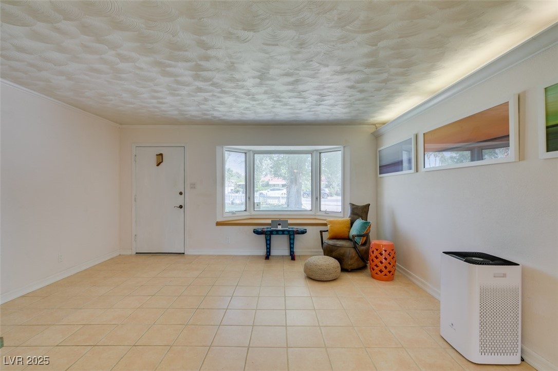 4087 Pleasant Road Las Vegas, NV 89108 - Photo 15 of 74 Living area with crown molding and light tile patterned floors