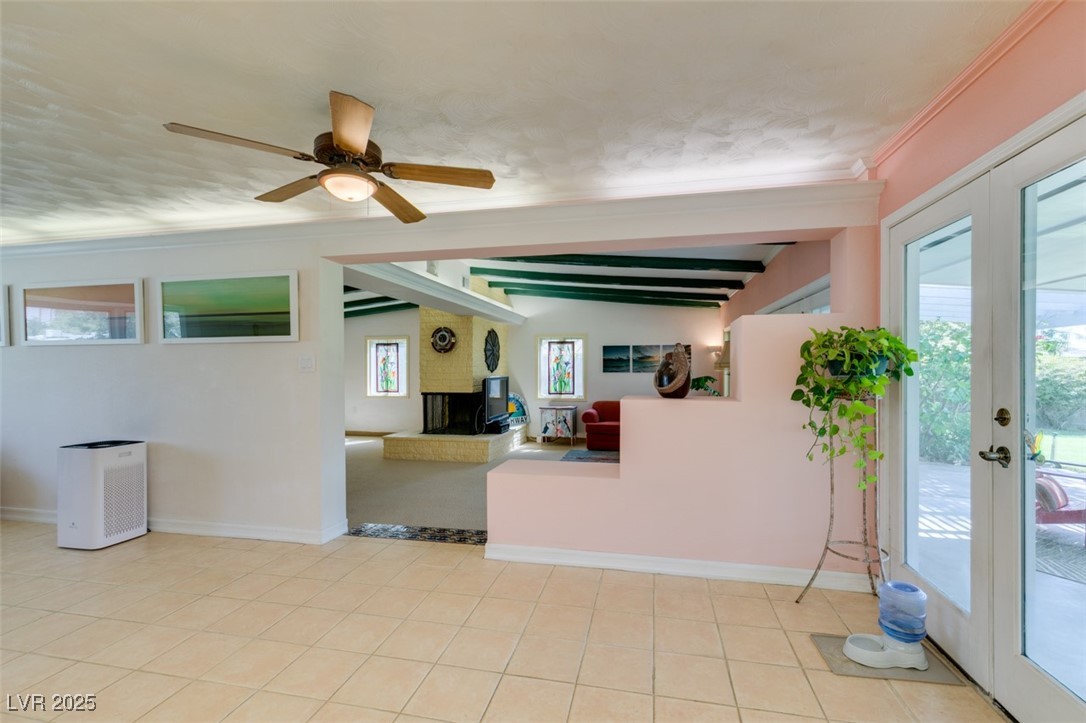 4087 Pleasant Road Las Vegas, NV 89108 - Photo 29 of 74 Living area with french doors, beam ceiling, ceiling fan, light tile patterned flooring, and crown molding