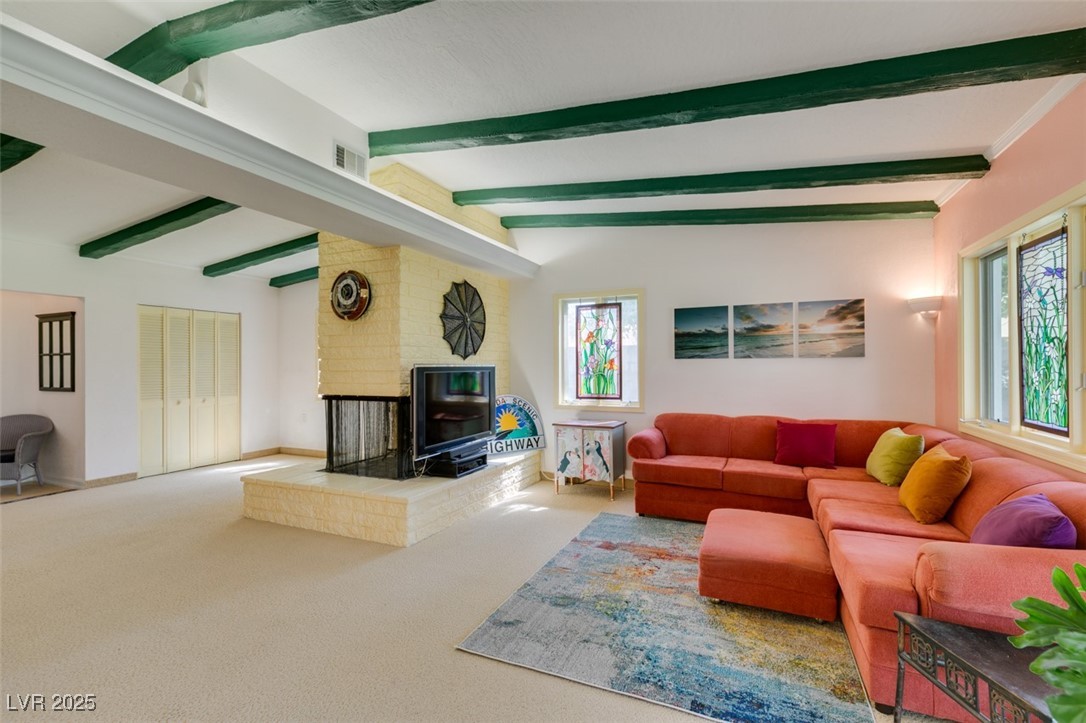 4087 Pleasant Road Las Vegas, NV 89108 - Photo 31 of 74 Living area featuring beam ceiling, carpet floors, and a fireplace