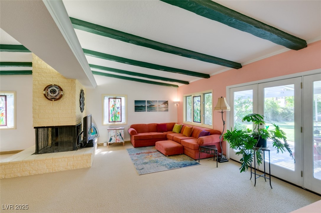 4087 Pleasant Road Las Vegas, NV 89108 - Photo 32 of 74 Living room featuring carpet flooring, healthy amount of natural light, a fireplace, and french doors