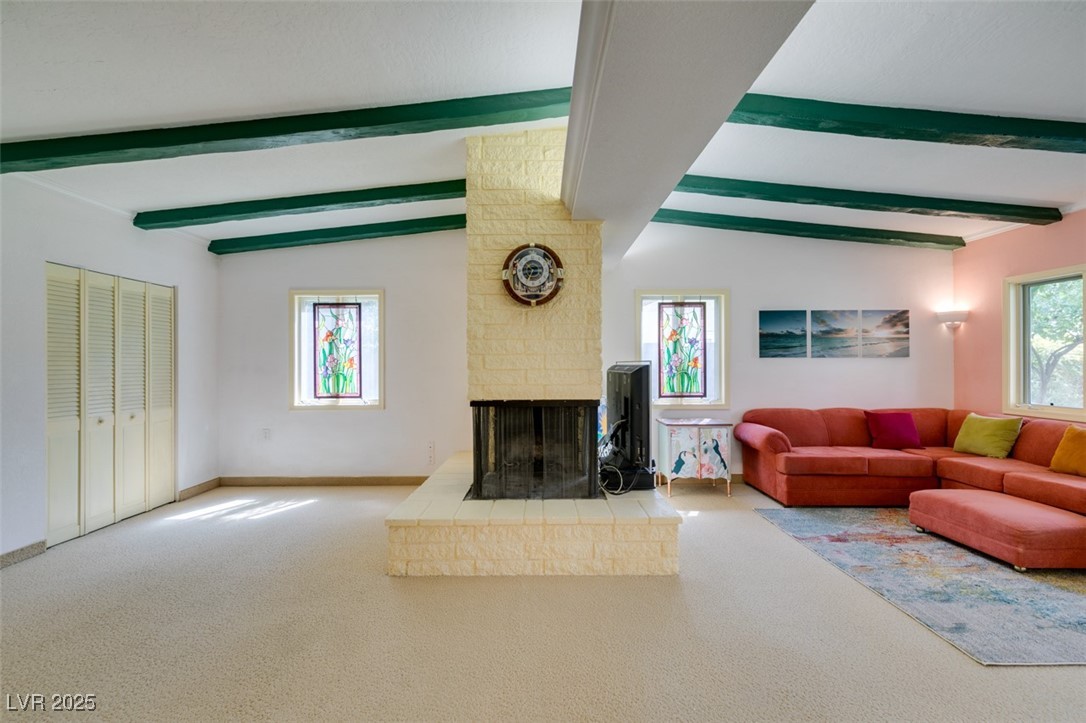 4087 Pleasant Road Las Vegas, NV 89108 - Photo 33 of 74 Living room with carpet floors, a multi sided fireplace, and healthy amount of natural light