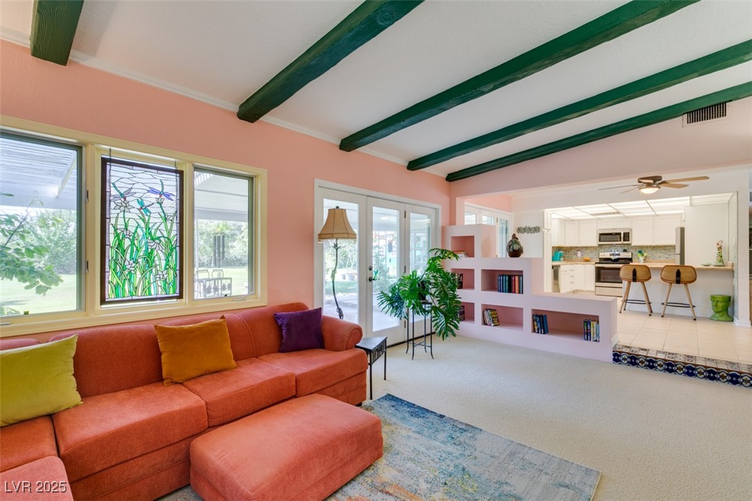 4087 Pleasant Road Las Vegas, NV 89108 - Photo 36 of 74 Living area with light carpet, beamed ceiling, french doors, and a ceiling fan