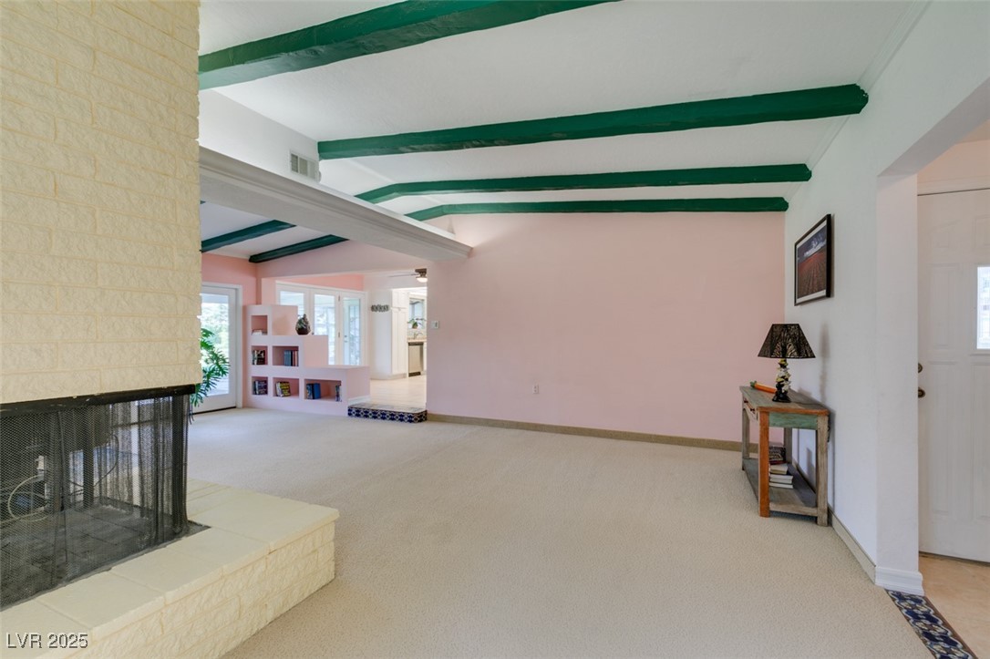 4087 Pleasant Road Las Vegas, NV 89108 - Photo 38 of 74 Unfurnished living room featuring a multi sided fireplace, beamed ceiling, and carpet