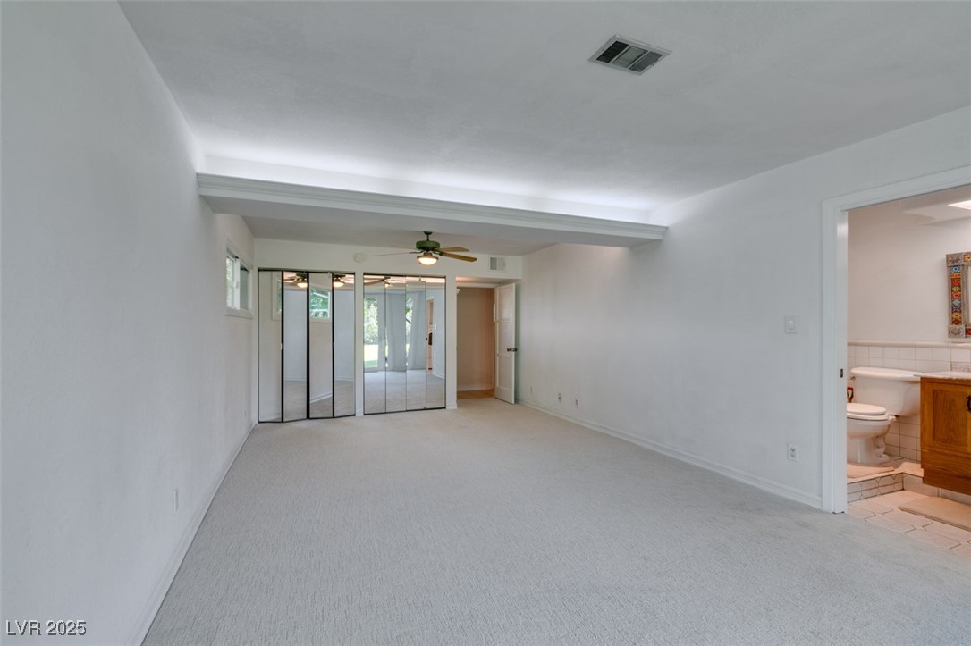 4087 Pleasant Road Las Vegas, NV 89108 - Photo 44 of 74 Empty room with light colored carpet and a ceiling fan