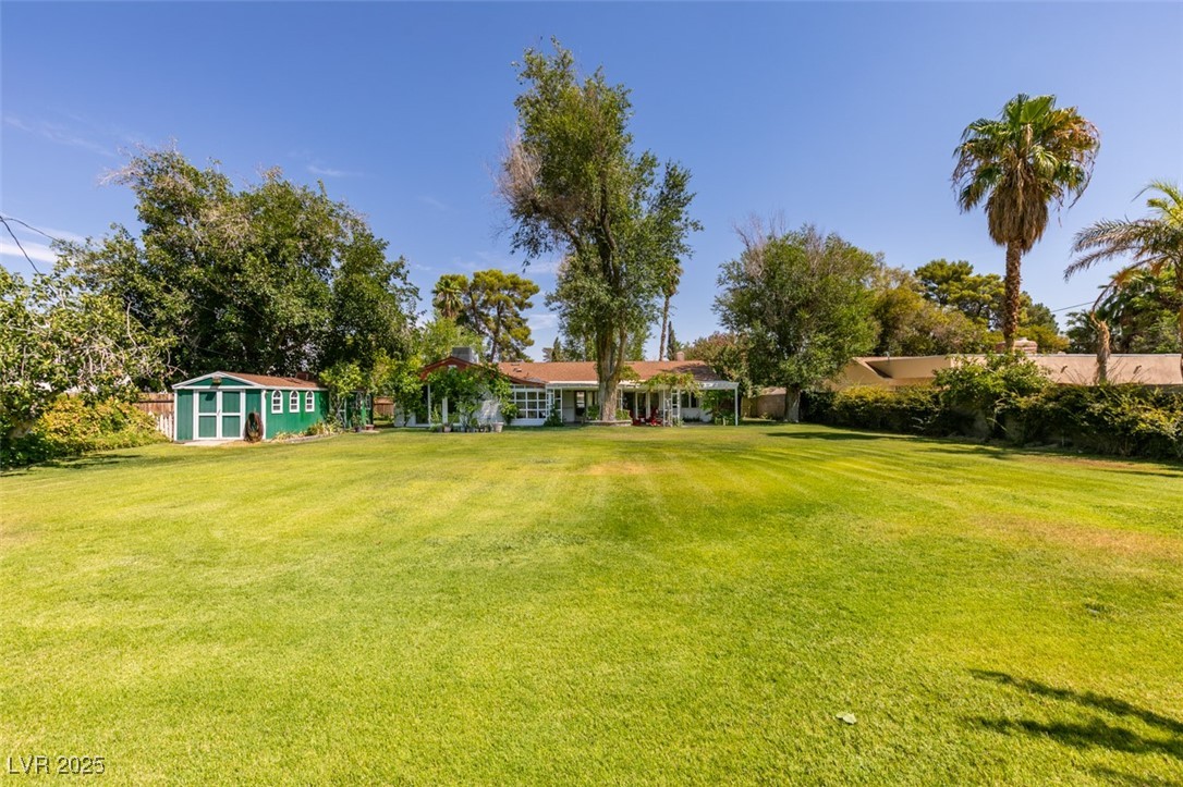 4087 Pleasant Road Las Vegas, NV 89108 - Photo 60 of 74 View of green lawn featuring a shed