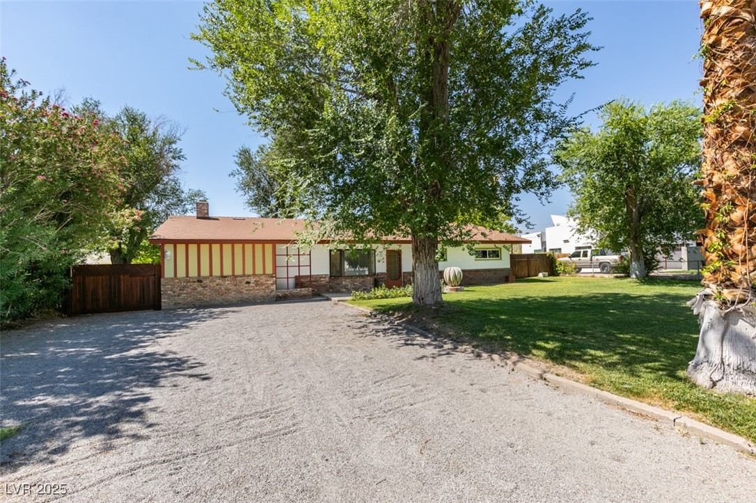 4087 Pleasant Road Las Vegas, NV 89108 - Photo 8 of 74 Ranch-style home with driveway, a chimney, and brick siding