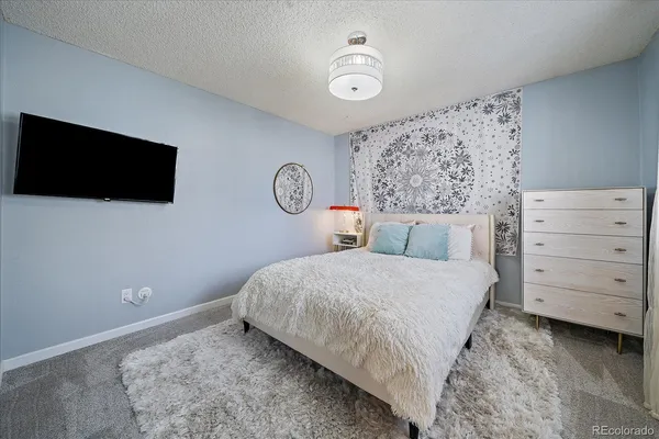 a bedroom with a bed and a flat screen tv