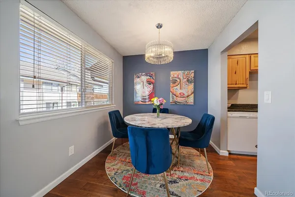 a view of a dining room with furniture wooden floor and chandelier