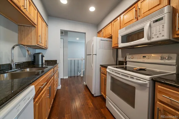 a kitchen with a stove sink and a microwave