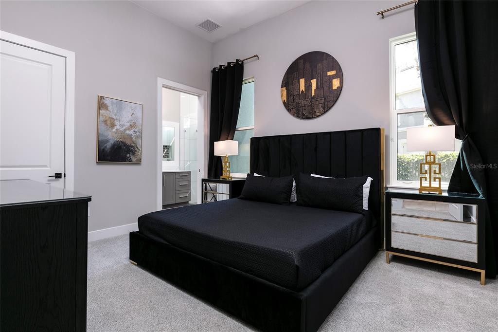 1514 Corolla Court Reunion, FL 34747 - Photo 18 of 74 a bedroom with a bed and a fireplace