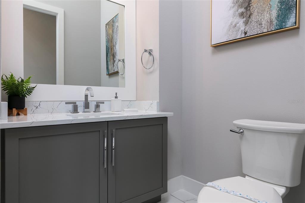 1514 Corolla Court Reunion, FL 34747 - Photo 22 of 74 a bathroom with a toilet sink and mirror