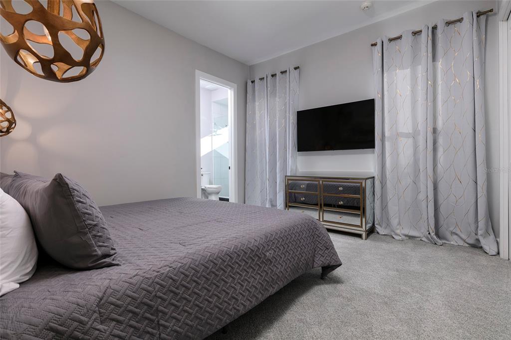 1514 Corolla Court Reunion, FL 34747 - Photo 45 of 74 a bedroom with a bed and a television