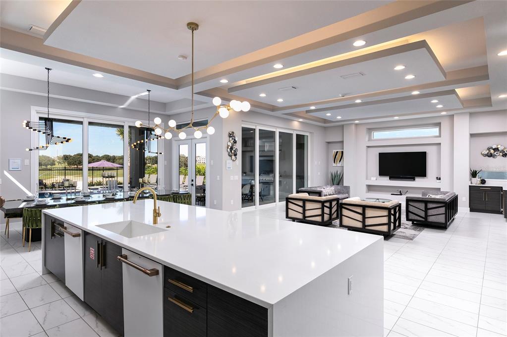 1514 Corolla Court Reunion, FL 34747 - Photo 5 of 74 a large living room with stainless steel appliances kitchen island granite countertop a table chairs and a sink