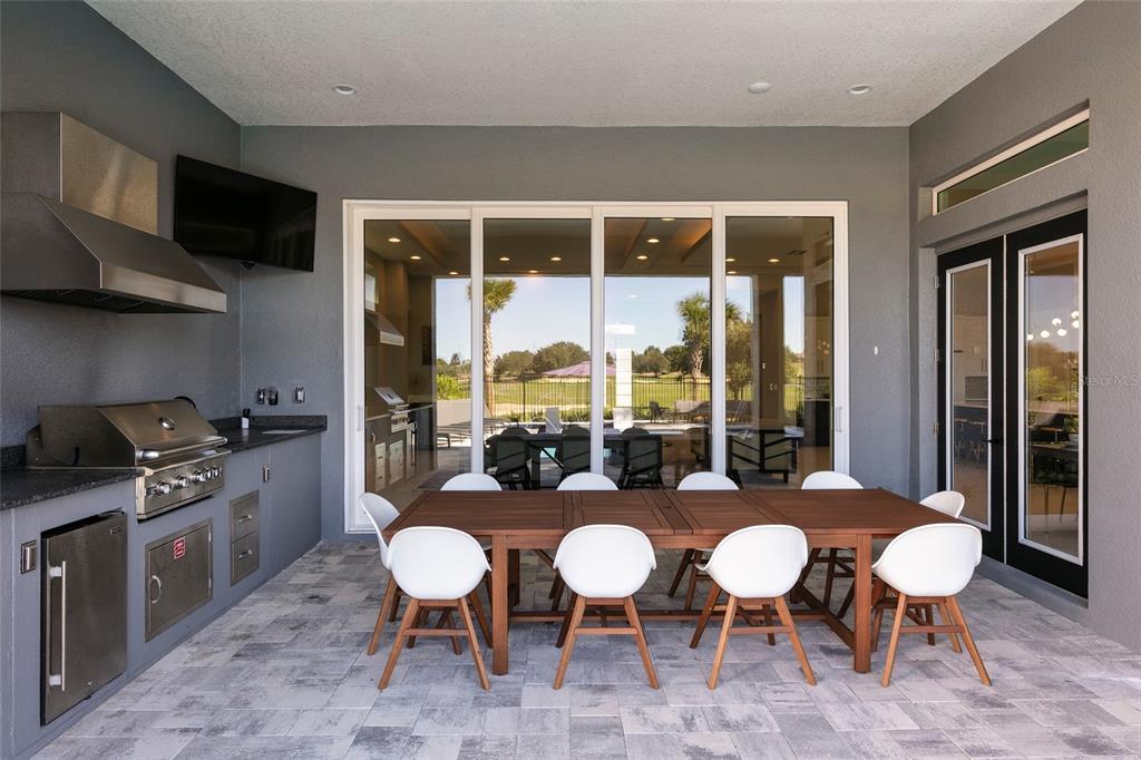 1514 Corolla Court Reunion, FL 34747 - Photo 56 of 74 a room with stainless steel appliances a dining table and chairs