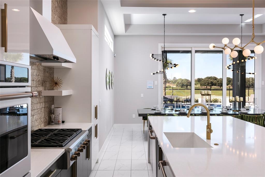 1514 Corolla Court Reunion, FL 34747 - Photo 8 of 74 a kitchen with stainless steel appliances granite countertop a stove and a refrigerator