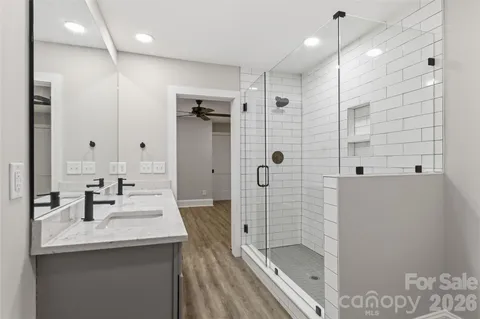 a bathroom with a shower sink and mirror