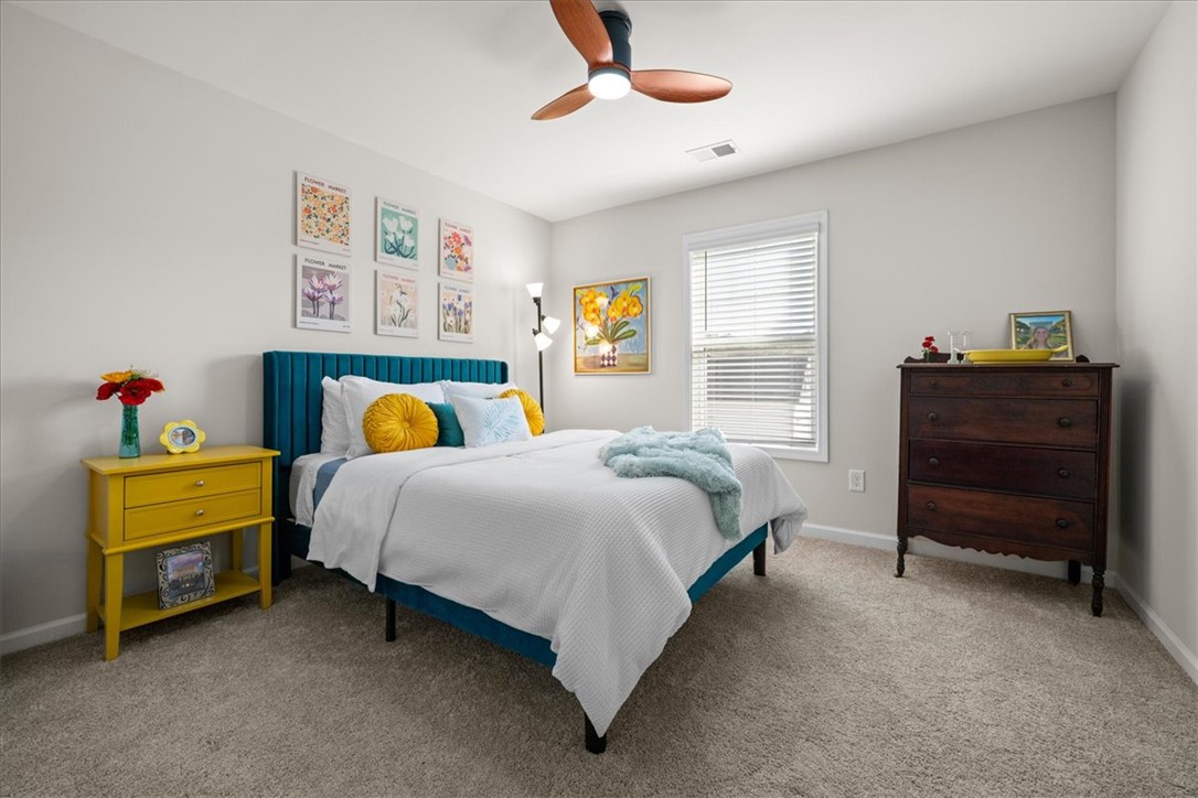 216 Carvel Trail Seneca, SC 29678 - Photo 32 of 48 This cozy bedroom features a window, a ceiling fan, and soft carpet flooring.