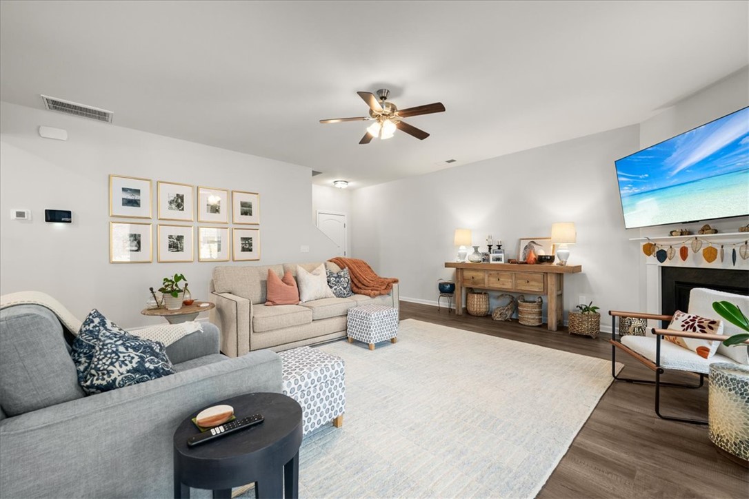216 Carvel Trail Seneca, SC 29678 - Photo 4 of 48 This inviting living area features warm lighting, durable flooring, and a cozy fireplace, perfect for everyday living.