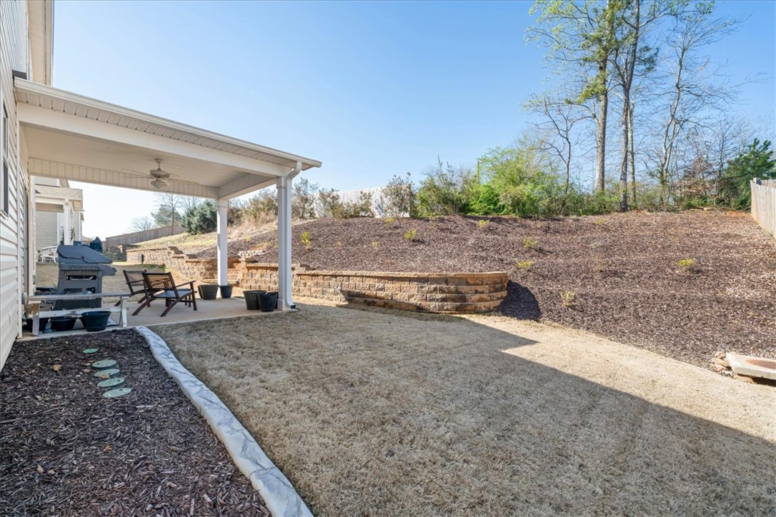 216 Carvel Trail Seneca, SC 29678 - Photo 47 of 48 This outdoor space offers a comfortable covered patio and a terraced yard, perfect for relaxation.