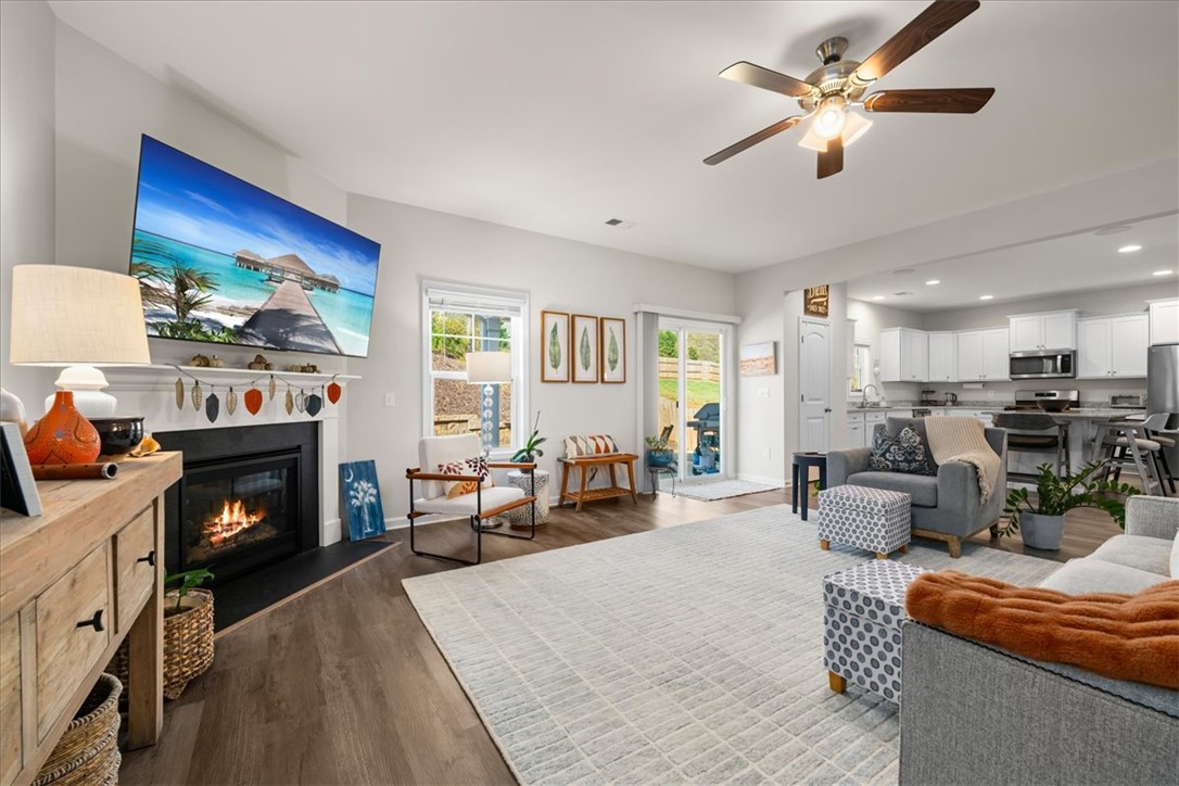 216 Carvel Trail Seneca, SC 29678 - Photo 5 of 48 This inviting space features a cozy fireplace, abundant natural light, and seamless outdoor access.
