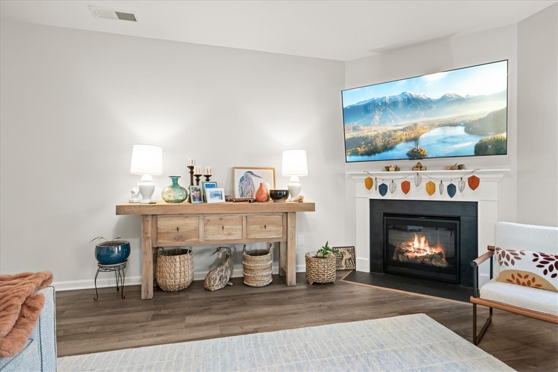 216 Carvel Trail Seneca, SC 29678 - Photo 7 of 48 This inviting living area features a warm fireplace and rich wood flooring.