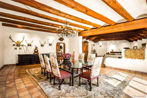 a view of a dining room with furniture and a rug