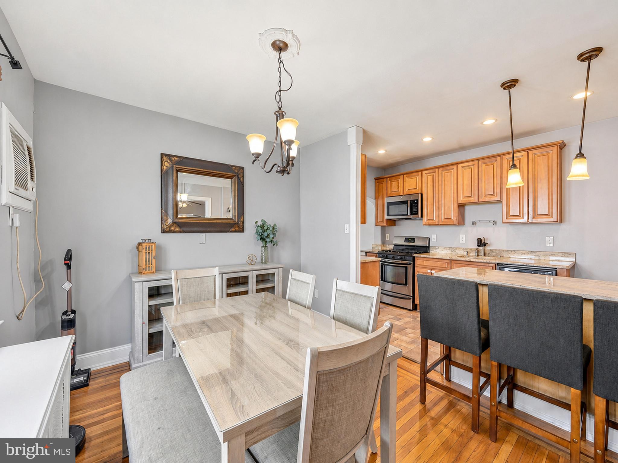 1210 Harding Drive Havertown, PA 19083 - Photo 6 of 25 a kitchen with a dining table chairs and refrigerator