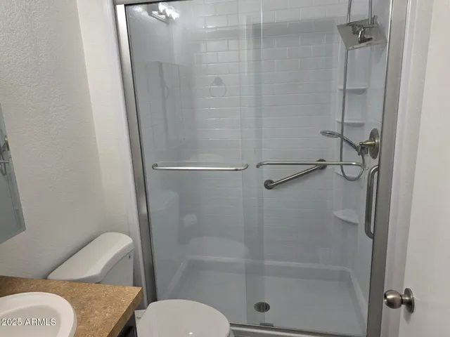 a bathroom with a toilet and a shower