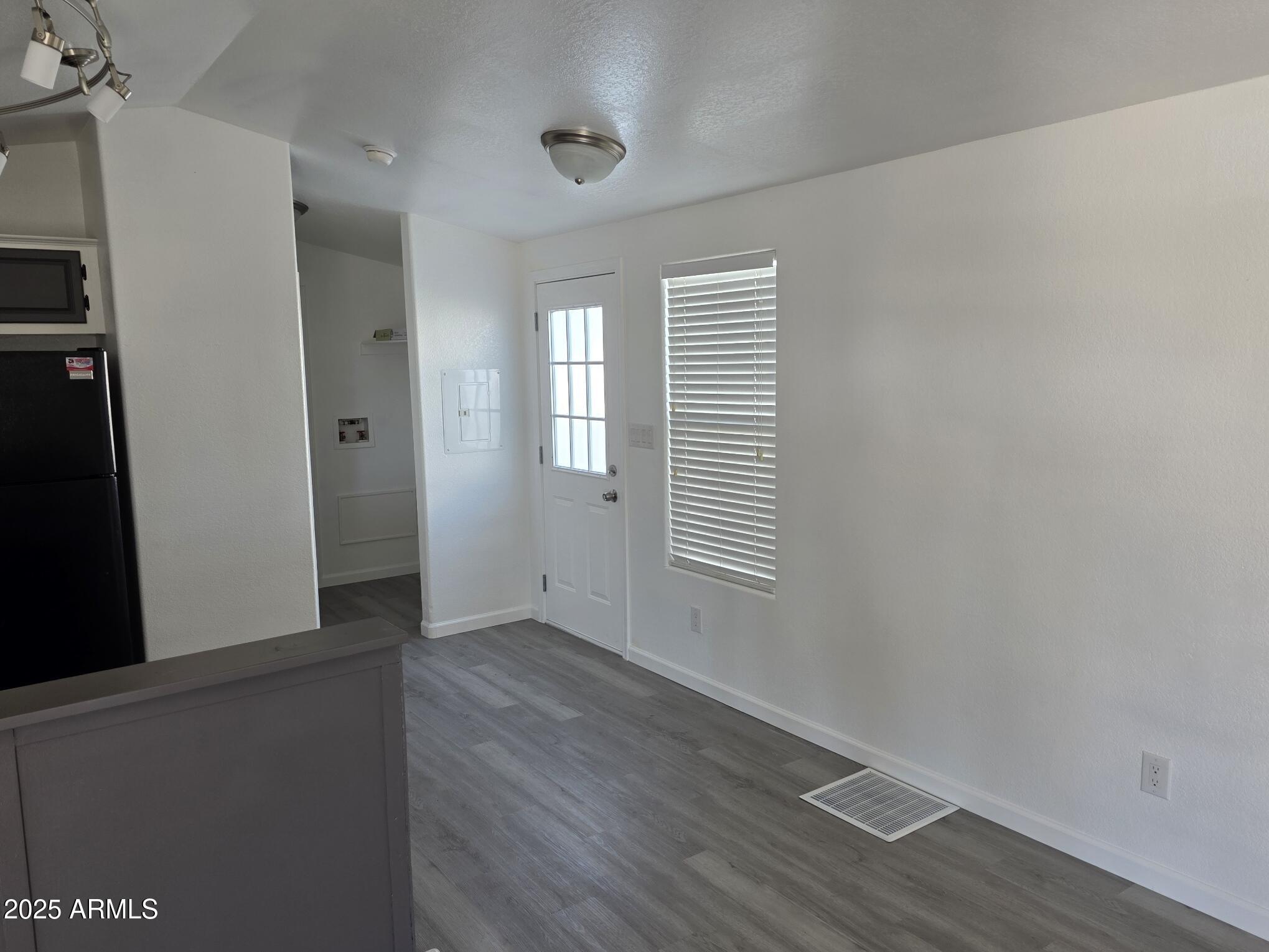 7807 East Main Street, Unit C6 Mesa, AZ 85207 - Photo 17 of 32 a view of an empty room with wooden floor and a window