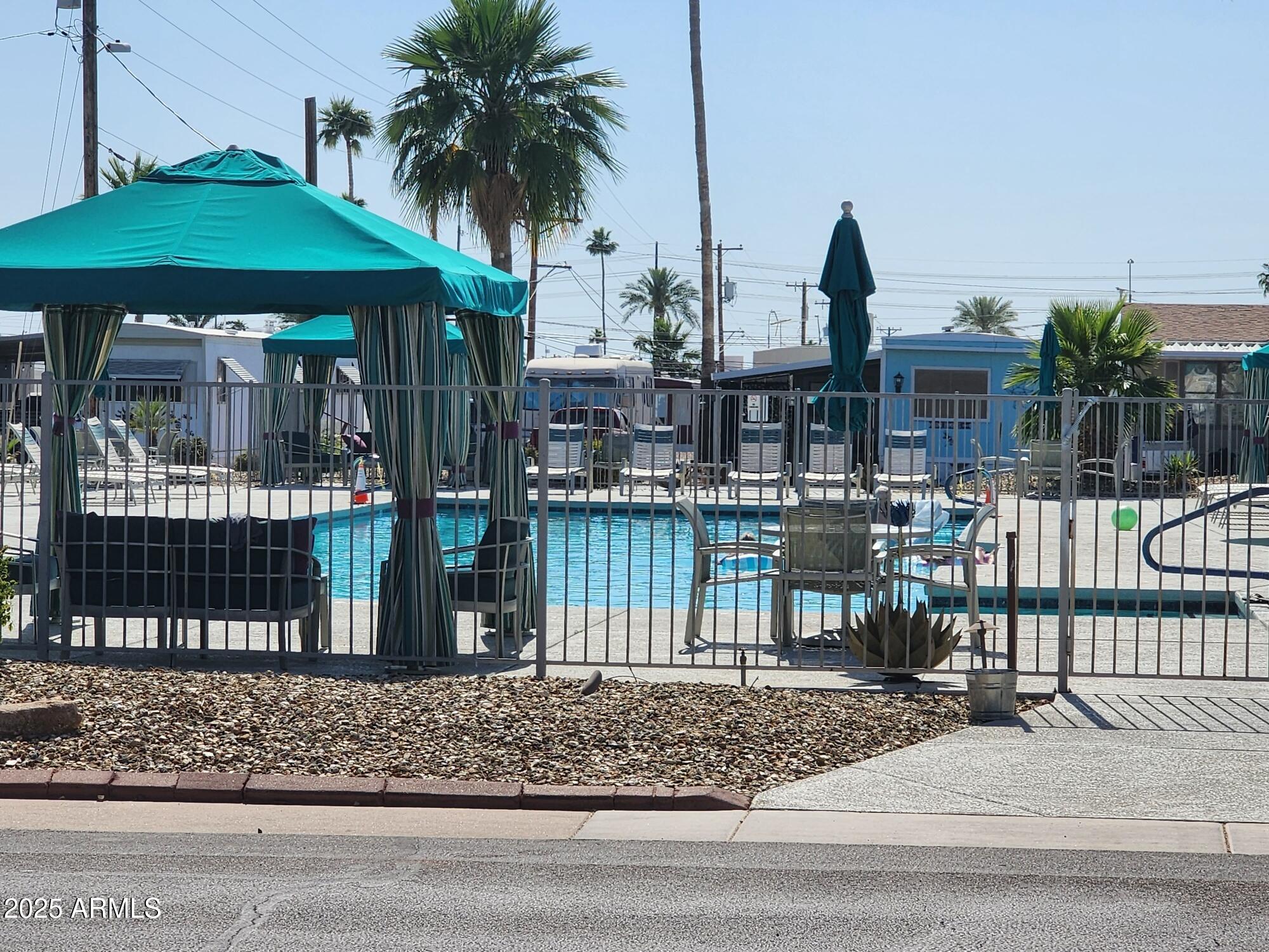 7807 East Main Street, Unit C6 Mesa, AZ 85207 - Photo 24 of 32 a front view of a house with garden