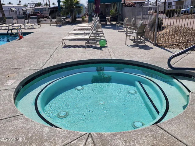 an aerial view of a swimming pool with outdoor seating