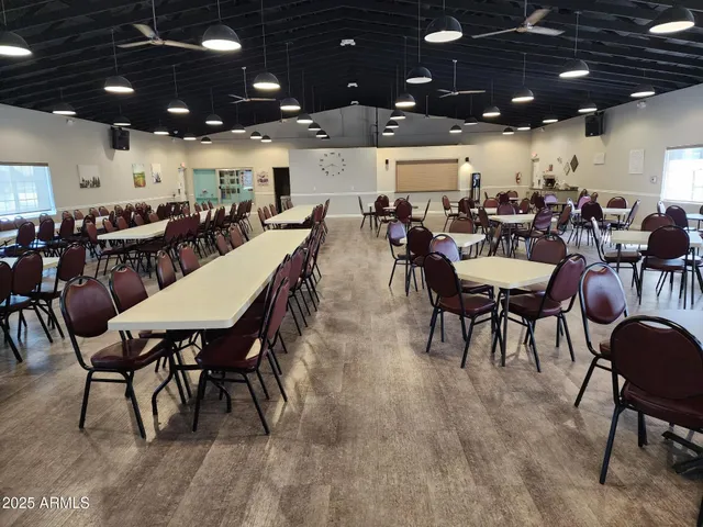 a outdoor dining space with lots of furniture and a projector