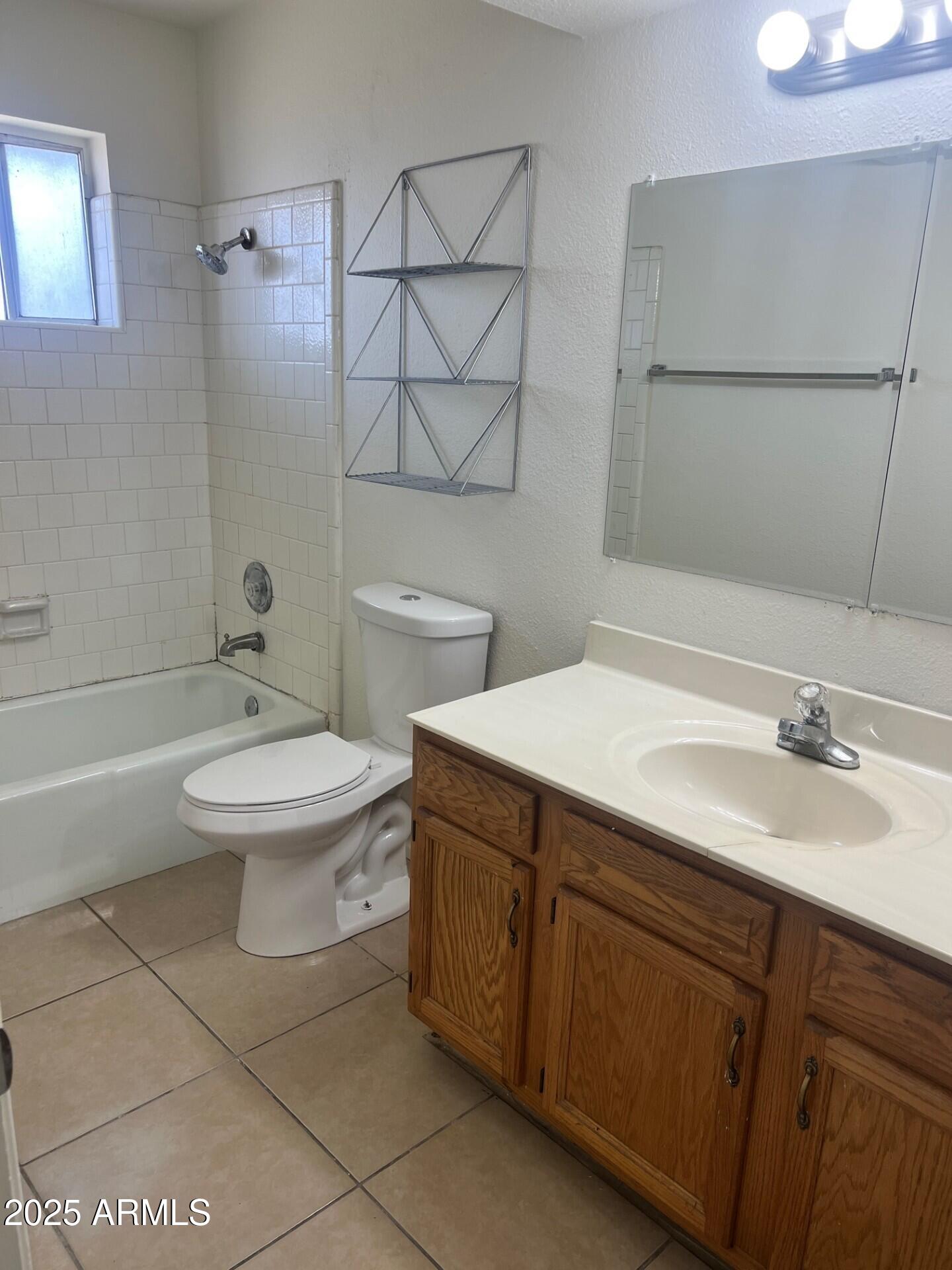 540 North Hall Mesa, AZ 85203 - Photo 5 of 9 a bathroom with a sink a toilet and shower