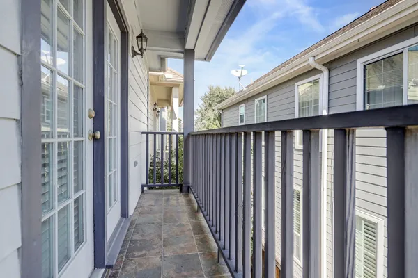 a view of a brick house with wooden fence