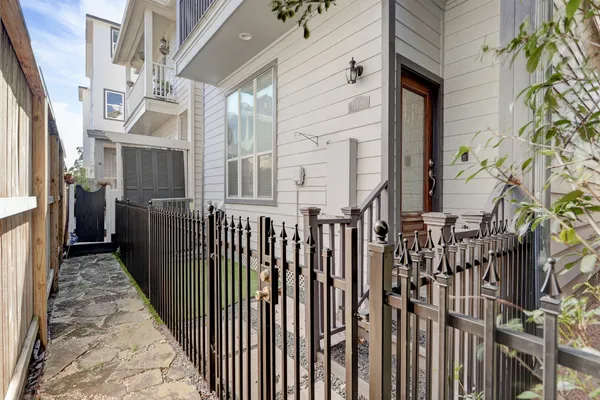 a view of a house with a wooden fence