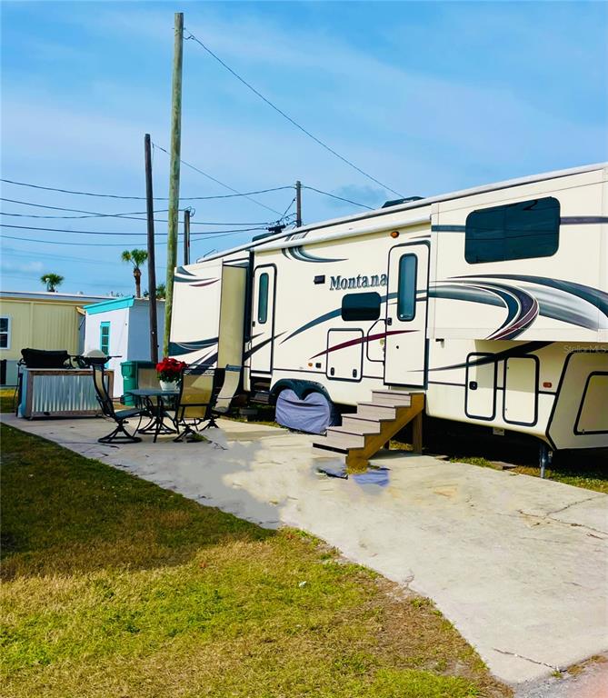 a view of a swimming pool with outdoor seating and a window