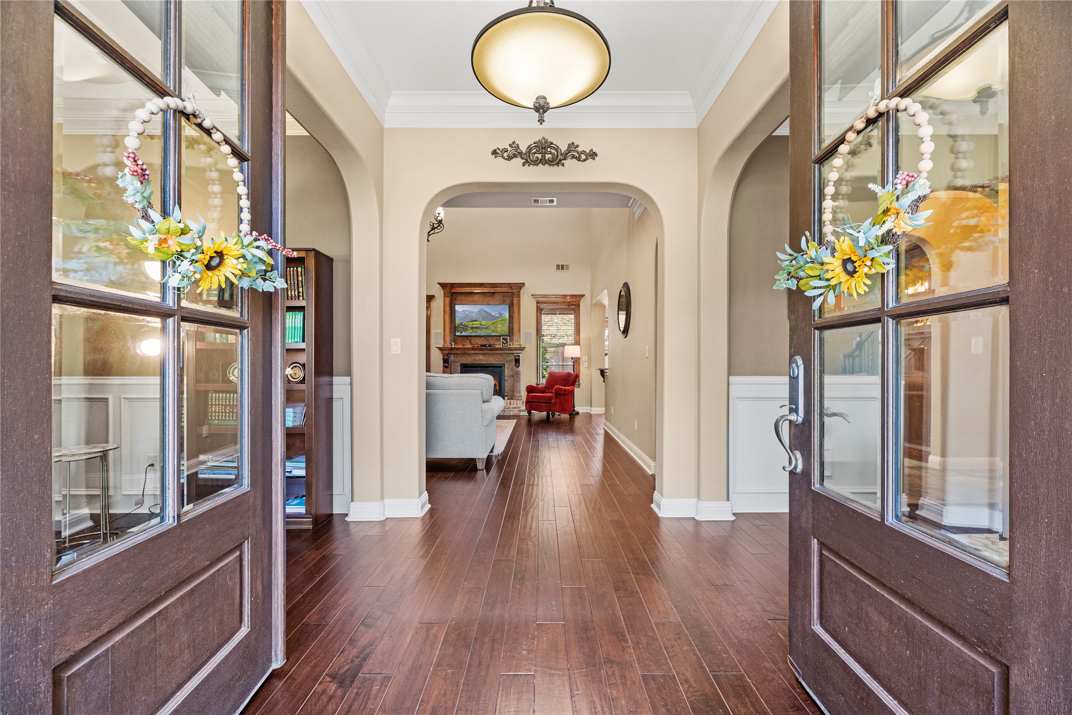 3550 Windrose Drive Beaumont, TX 77706 - Photo 12 of 50 Welcoming entryway with rich hand-scraped luxury engineered wood floors, graceful archways, and direct sightlines to the living room fireplace. Elegant and inviting from the moment you walk in.
