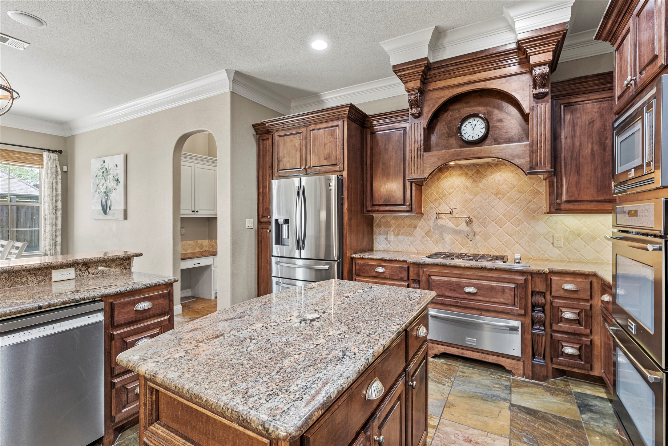 3550 Windrose Drive Beaumont, TX 77706 - Photo 19 of 50 Beautifully connected to the breakfast and family areas with a bright, open layout. Natural light enhances the granite surfaces and rich millwork, creating a warm and welcoming space.