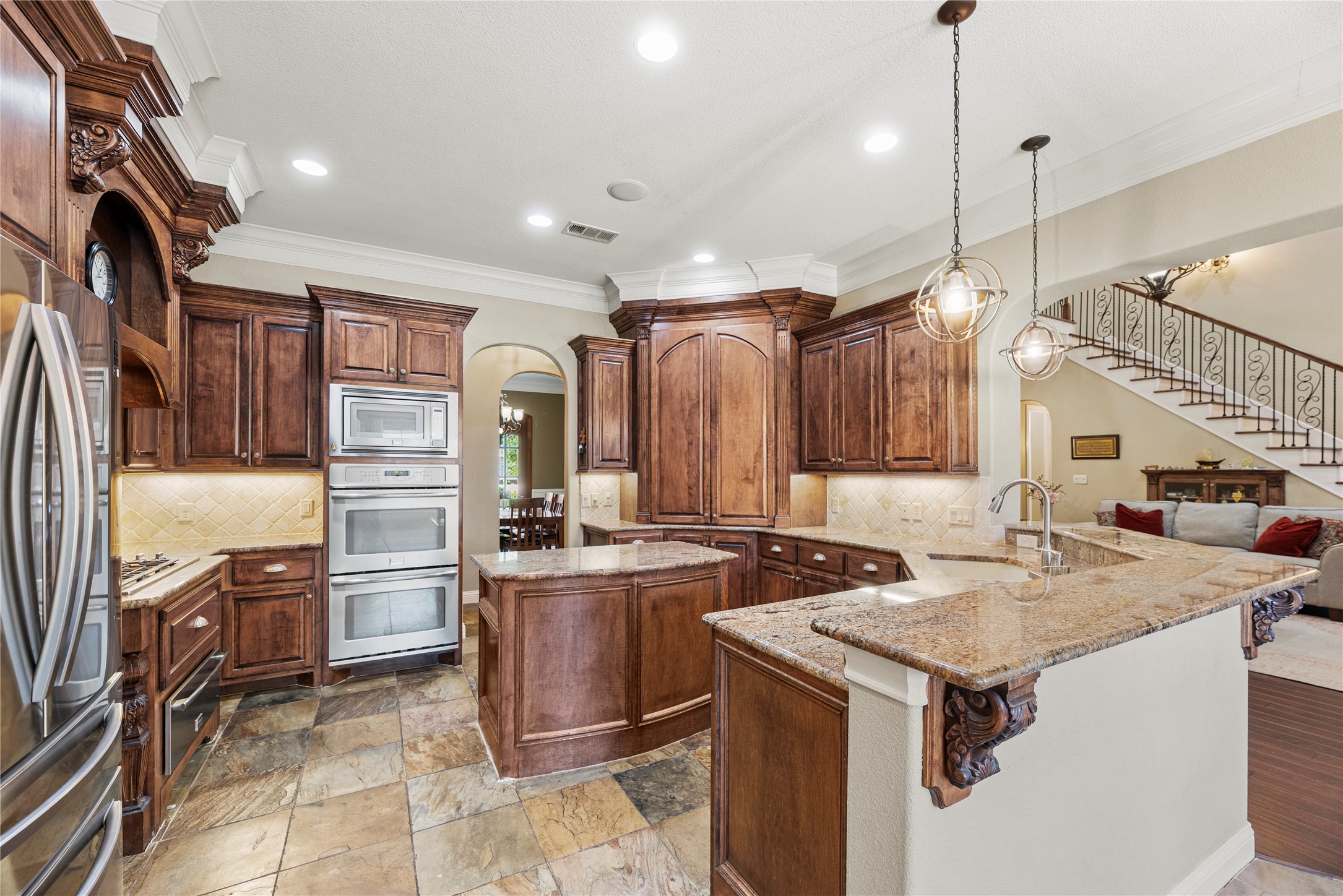 3550 Windrose Drive Beaumont, TX 77706 - Photo 23 of 50 Expansive kitchen layout featuring a large central island, raised serving bar, and open sightlines to the living room — ideal for both everyday living and entertaining.