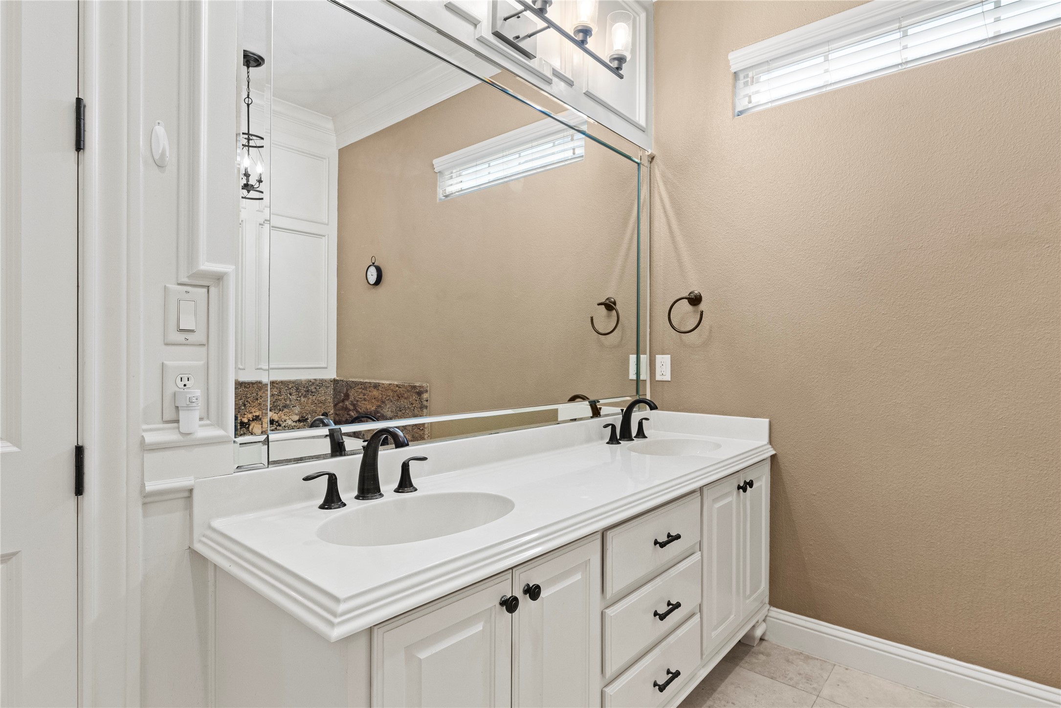 3550 Windrose Drive Beaumont, TX 77706 - Photo 27 of 50 Generous double vanity with framed mirror, bronze fixtures, and plenty of storage — blending function and timeless design.