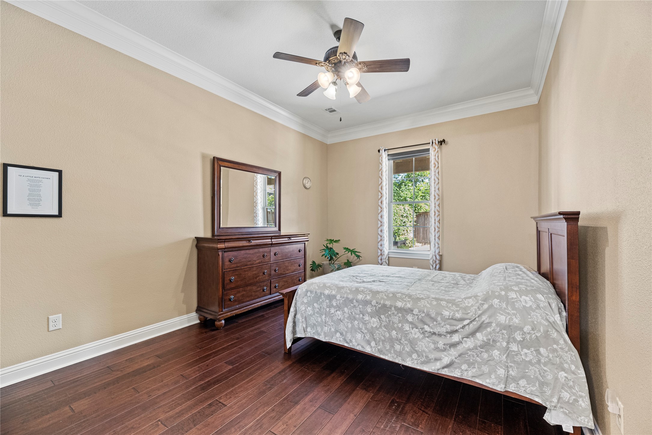 3550 Windrose Drive Beaumont, TX 77706 - Photo 30 of 50 Spacious first-floor bedroom featuring hand-scraped luxury engineered wood floors, crown molding, and a bright window overlooking the backyard. Perfect for guests, extended family, or multi-generational living.