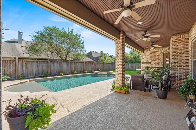 a view of a porch with furniture and garden