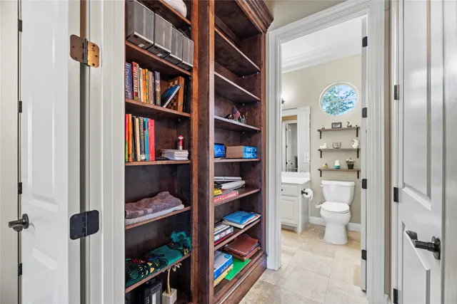 a bathroom with a toilet sink and mirror