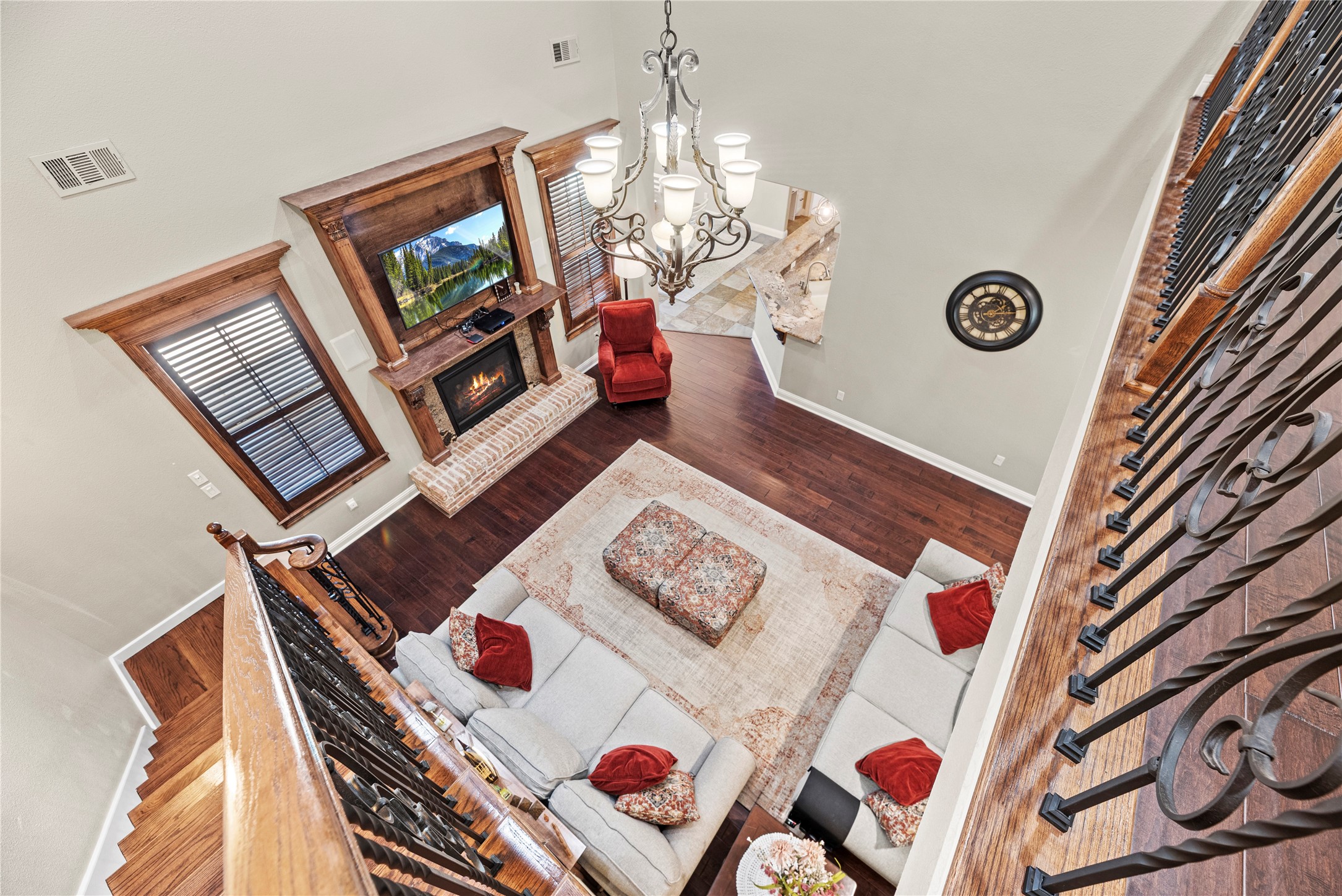 3550 Windrose Drive Beaumont, TX 77706 - Photo 34 of 50 Beautiful bird’s-eye view of the two-story living room highlighting the elegant coffered ceiling, rich millwork, and hand-scraped luxury engineered wood floors below.