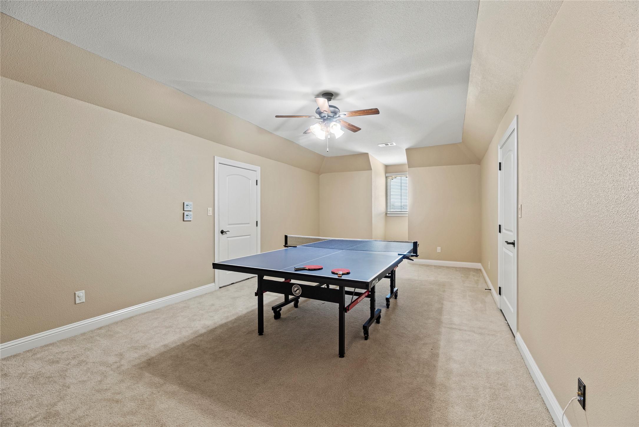 3550 Windrose Drive Beaumont, TX 77706 - Photo 39 of 50 Expansive upstairs game room offering flexible space for recreation, hobbies, or a home gym. Both sides include finished attic storage (not pictured), ideal for keeping seasonal items neatly tucked away.