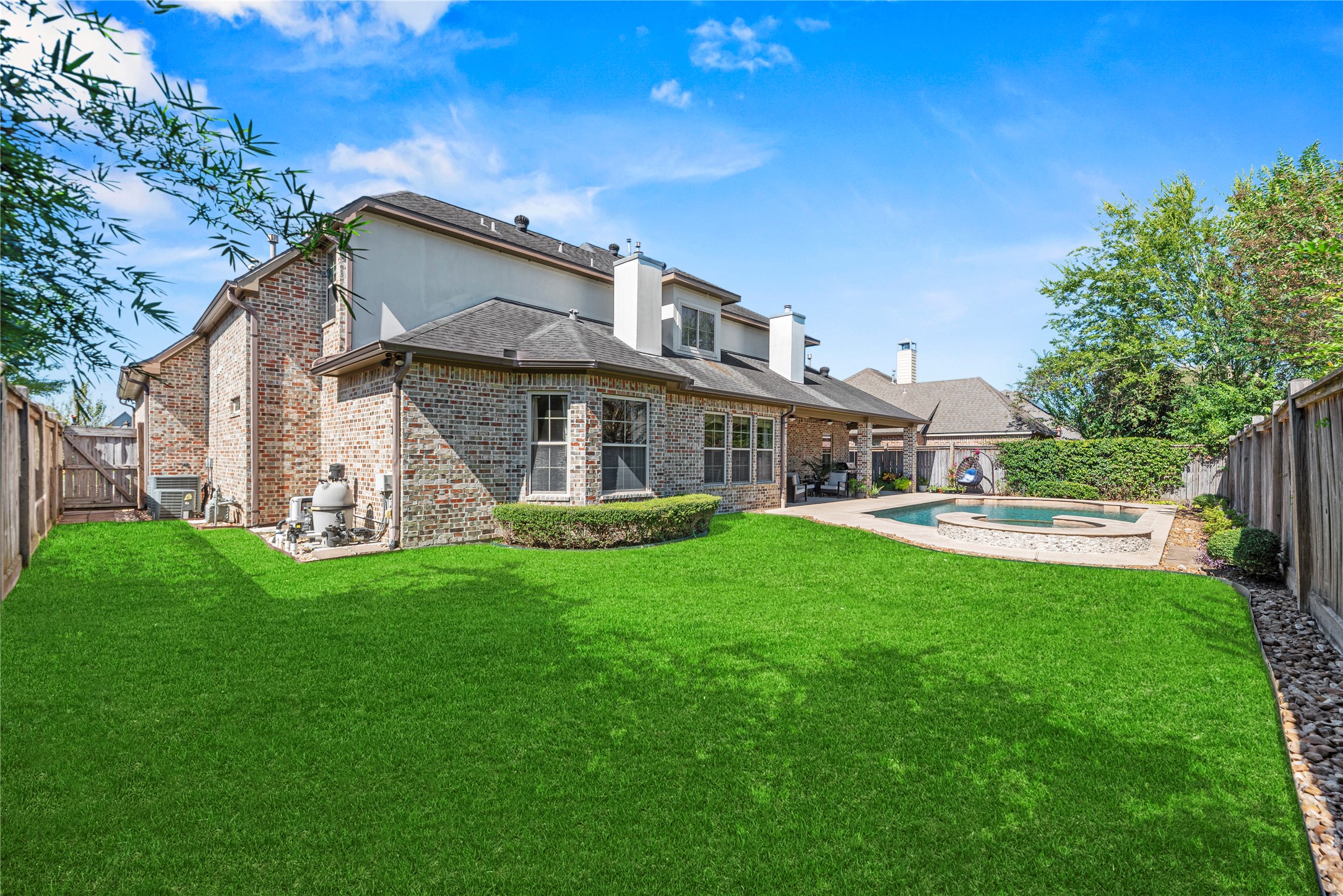 3550 Windrose Drive Beaumont, TX 77706 - Photo 44 of 50 Expansive fenced backyard with manicured lawn and sparkling pool — perfect balance of green space and outdoor living. Plenty of room for play, pets, or future garden additions.