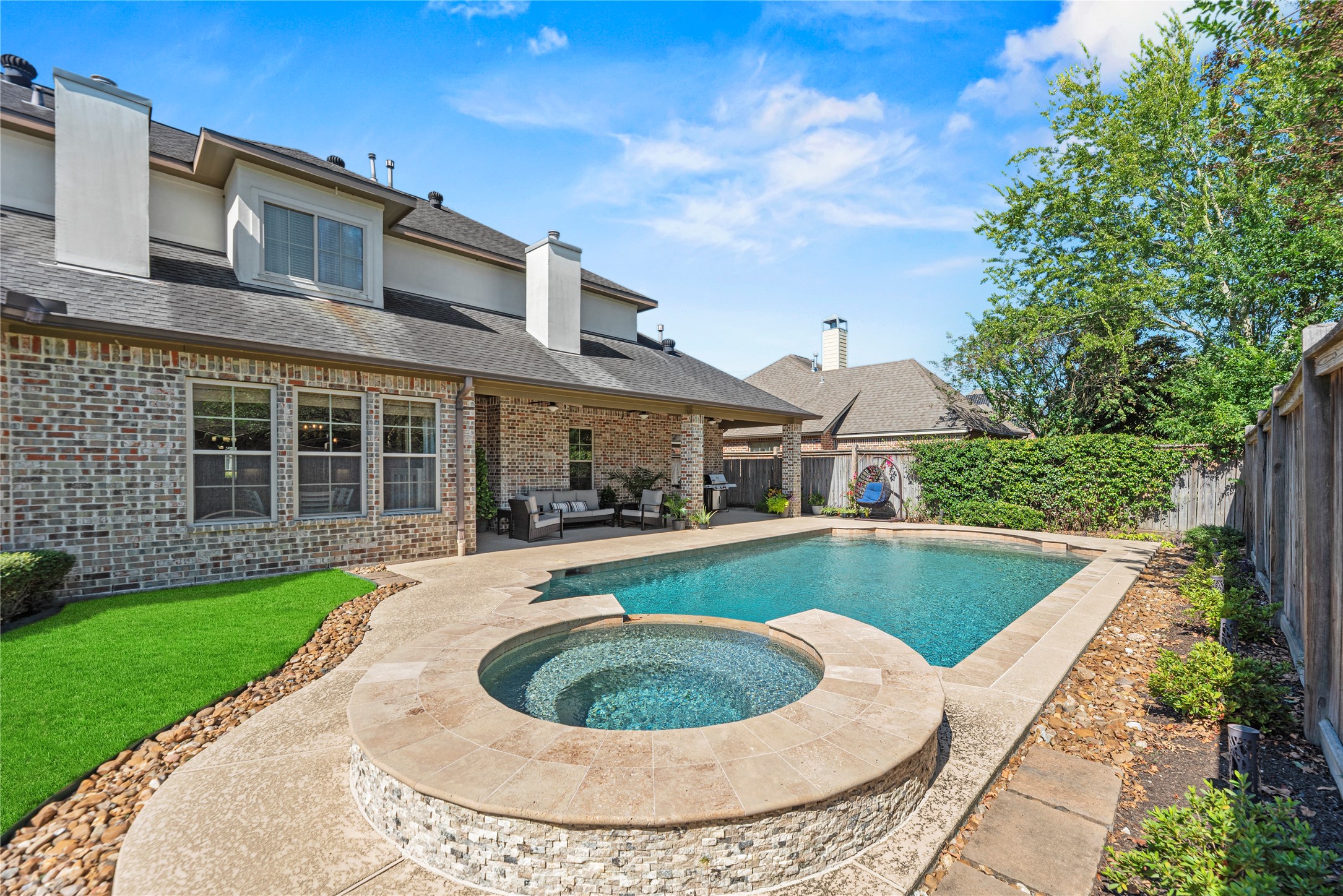 3550 Windrose Drive Beaumont, TX 77706 - Photo 6 of 50 Beautiful raised spa with stone accents and waterfall feature cascading into the pool. A perfect setting for relaxation and entertaining in style.