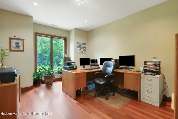 a workspace with furniture window and wooden floor