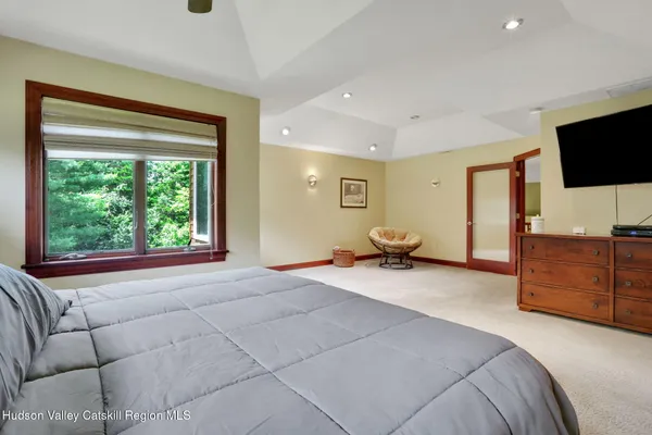 a bedroom with furniture and a flat screen tv